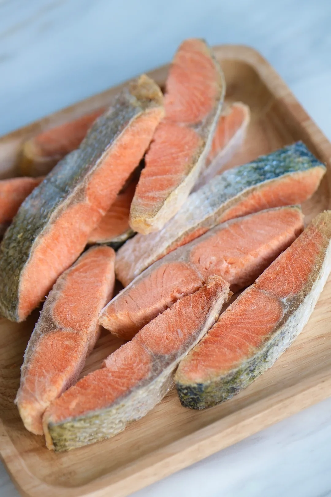 Salmon pieces arranged on a wooden board